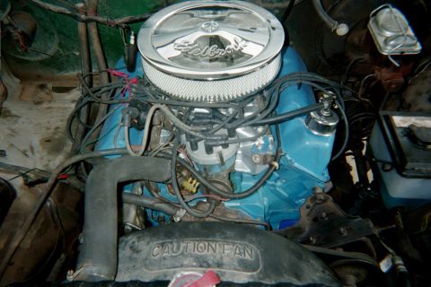 1978 Ford Bronco - The engine bay features a blue Ford V8 engine with a chrome Edelbrock air cleaner and visible "CAUTION FAN" text on the shroud.