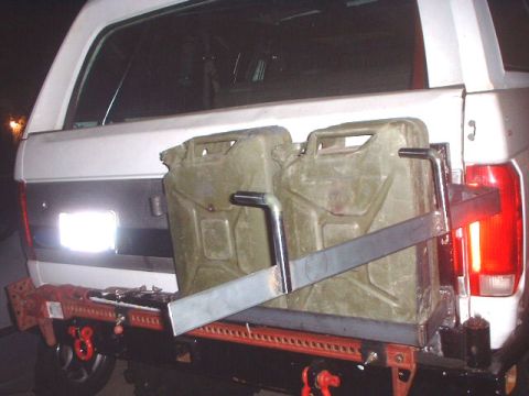 1995 Ford Bronco - has a hinge and swings open. when its closed you can put a lock on it to keep it secure..