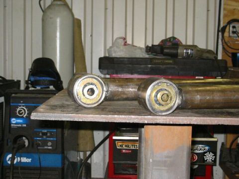 1994 Ford Bronco - Custom suspension components are shown on a workbench, with welding equipment in the background.