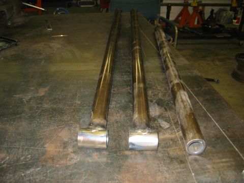 1994 Ford Bronco - Metal tubes are laid out on a workbench, possibly for fabrication or repair work.