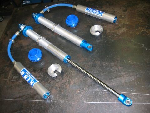 1994 Ford Bronco - King Off-Road Racing Shocks are displayed with their associated components on a workbench.