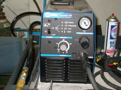 1994 Ford Bronco - A Miller Spectrum 375 plasma cutter is shown with various controls and a pressure gauge.