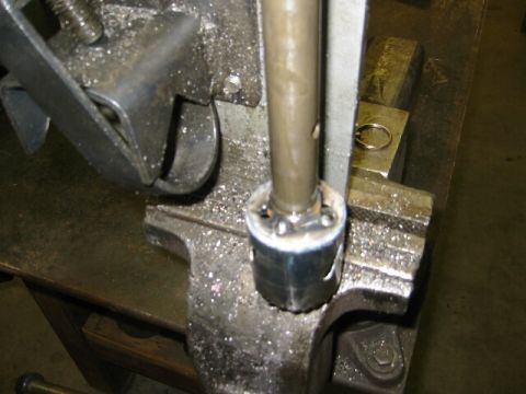 1994 Ford Bronco - A metal part is secured in a vise, possibly for repair or modification.