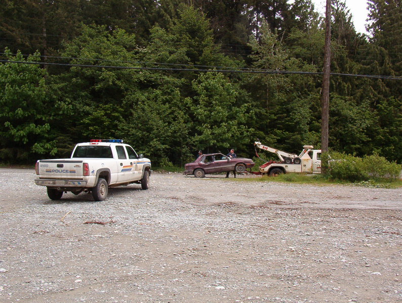 Then this tow truck shows up. Turns out that there was a large group of kids camping at Elbow Lake, and one of them backed this car into the lake. We saw three young bears off in the field at the start of the Chehalis FSR; they ran off when we stopped. When we drove by the camp at Elbow Lake, there were LOTS of campers, garbage everywhere, and two other cars that were torched.