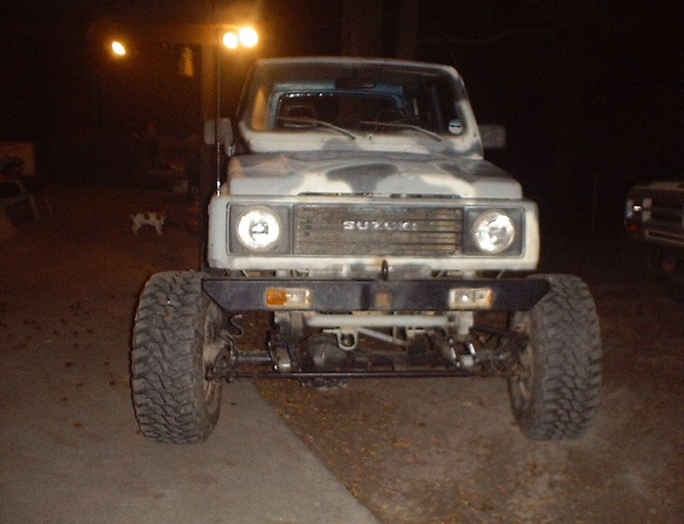 Suzuki Samurai with camouflage paint and aftermarket bumper