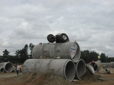 RC monster truck upside down on concrete pipes