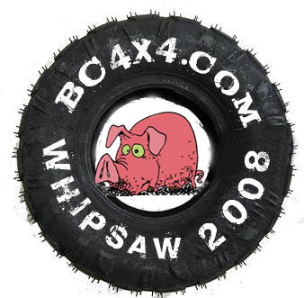 1985 Ford Bronco - An off-road tire hand-painted with "BC4X4.COM WHIPSAW 2008" surrounding a cartoon pink pig, a trail-event logo graphic. Not a build photo.