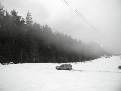 1985 Ford Bronco - Inder plowing through the snow under the powerlines.