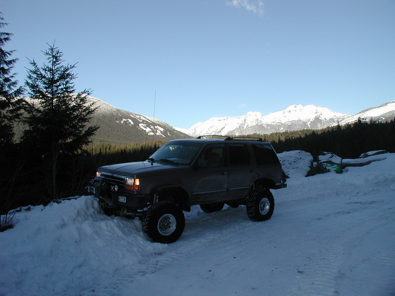 Lifted SUV in a snowy mountain landscape