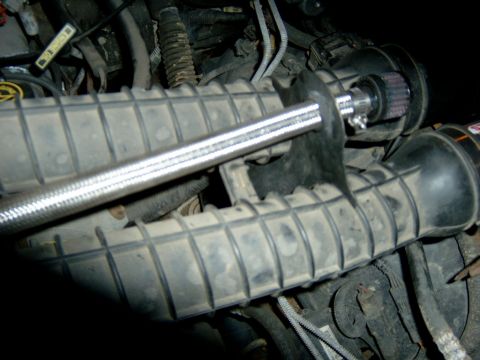 1995 Ford Bronco - Close-up of an engine's air intake system, possibly modified with an aftermarket filter.