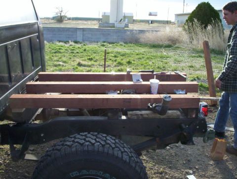 1978 Ford Bronco - Truck bed carrying lumber with a person and tools nearby.