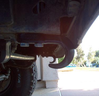 1988 Ford Bronco - Close-up view of a vehicle's tow hook and tire from a low angle.