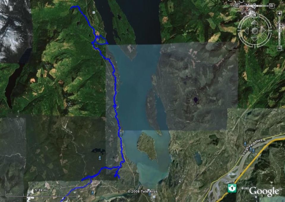 Satellite map showing a blue route through a mountainous, watery landscape with a highway.