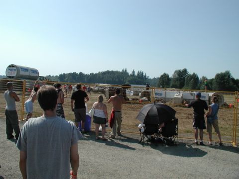 People watching an event behind a fence