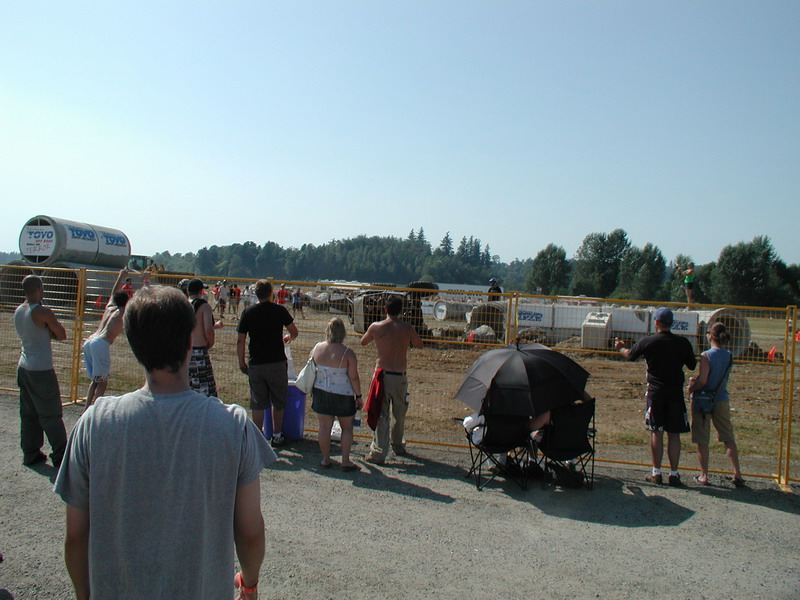 People watching an event behind a fence