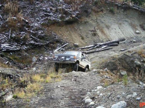 1985 Ford Bronco - Tracy going through a cross ditch on a dead end trail.