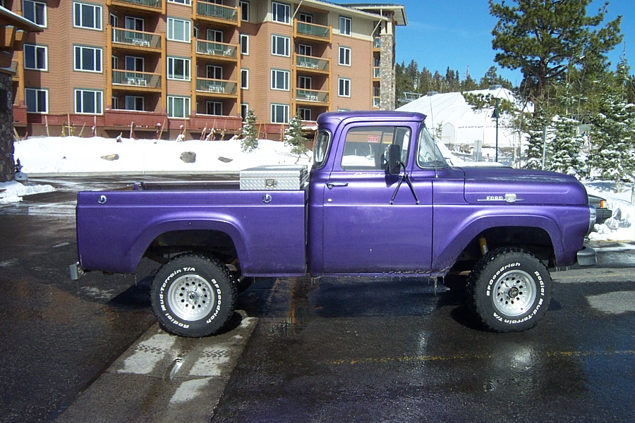 purple 1959 Ford F-100 pickup truck parked outside a building in the snow