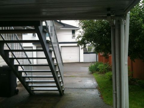 1990 Ford F-250 - This is a scene of an outdoor area with a metal staircase leading up to a building. A driveway and lawn are visible, along with trees and a…