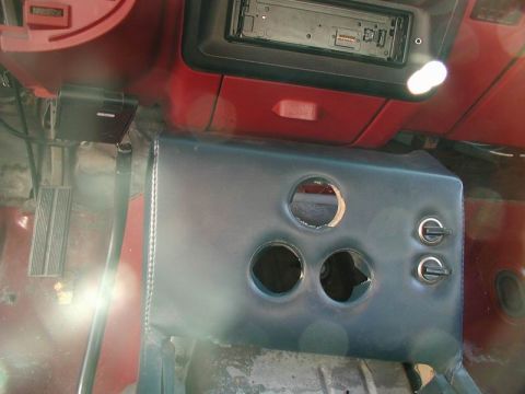 1990 Ford F-250 - Interior view of a custom center console in a vehicle, featuring cutouts for accessories and two toggle switches.