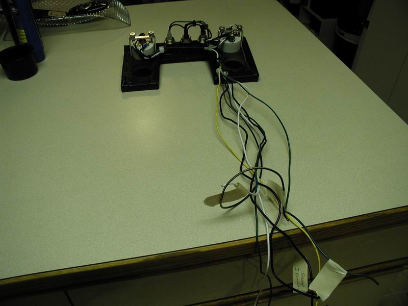Telegraph key with wires connected, on a countertop.