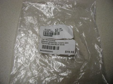 1990 Ford F-250 - A clear plastic bag containing two white labels with product information and barcodes. One label reads "Price: $19.95 LOCKN SIL BRK LVR TRE…