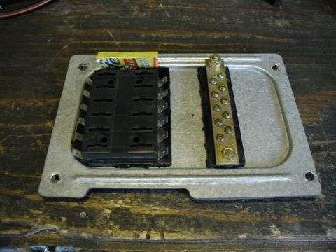 1990 Ford F-250 - Auxllary fuse panel and ground bar mounted to the right panel that is behind the kick-panel.