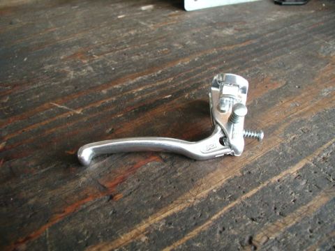 1990 Ford F-250 - A silver bicycle brake lever with the number "321" visible is resting on a weathered wooden surface.