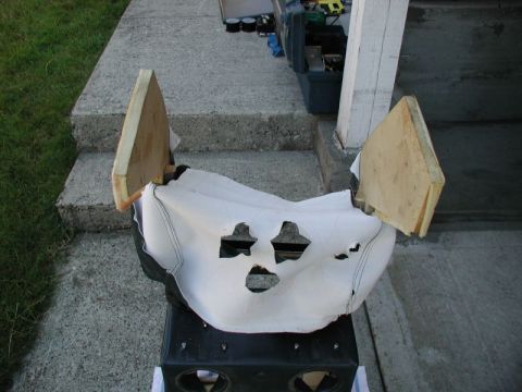 1990 Ford F-250 - A white, torn piece of material with cutouts resembling a face is draped over a black object. Two triangular wooden pieces are attached to…