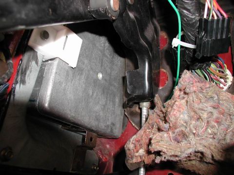 1990 Ford F-250 - This is a close-up view of the interior of a vehicle, focusing on the driver's side footwell area. Visible components include a black metal…