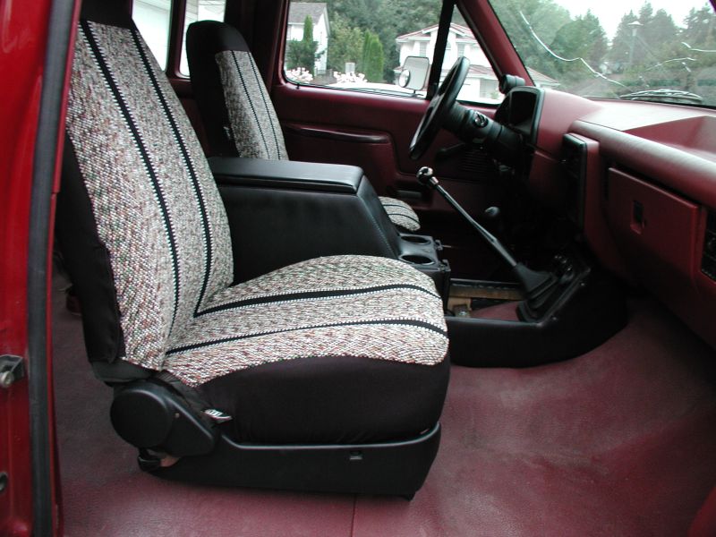 Interior of a red Ford F-250 pickup truck showing the driver's seat, center console, and dashboard.
