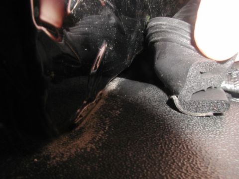 1990 Ford F-250 - A close-up view shows a black rubber seal with a foam core, possibly from a door or trunk, being held by a hand. The seal is positioned aga…