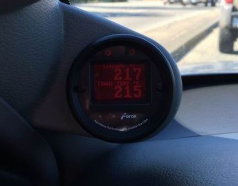 2002 Pontiac Grand Prix - A close-up view of a digital gauge cluster displaying engine coolant temperature at 217 degrees and transmission temperature at 215 degrees…