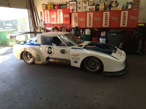 2002 Pontiac Grand Prix - A custom white and blue racing car with a large rear wing is parked in a garage. The car has the number '8' on its side and exposed engine…
