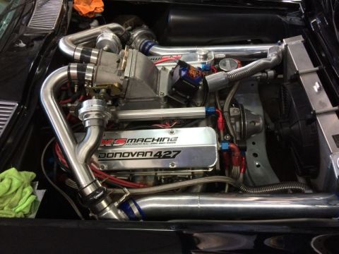 2002 Pontiac Grand Prix - A highly modified engine bay is shown, featuring a Donovan 427 engine with a supercharger and extensive polished aluminum piping. The engin…