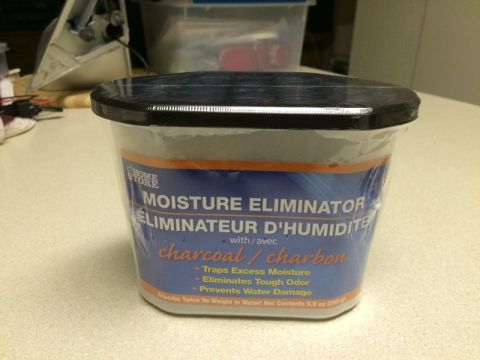 2002 Pontiac Grand Prix - A container of Home Store brand Moisture Eliminator with charcoal is shown on a table.