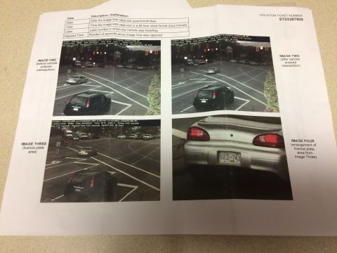 2002 Pontiac Grand Prix - This document contains four images related to a traffic violation, including two images of a black SUV at an intersection and a close-up of…