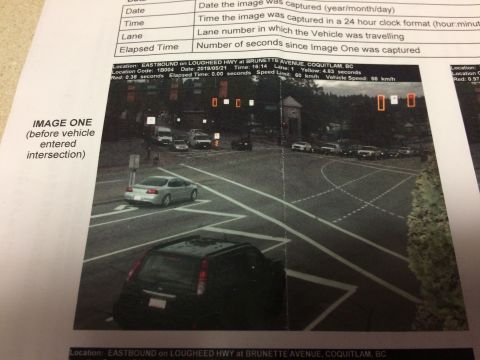 2002 Pontiac Grand Prix - A silver 2002 Pontiac Grand Prix is captured in motion at an intersection, with a black SUV visible in the foreground. The image is part of…