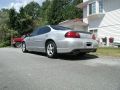 2002 Pontiac Grand Prix - The rear driver's side of a silver 2002 Pontiac Grand Prix is shown parked on a street. The car has tinted windows and a subtle rear spoile…