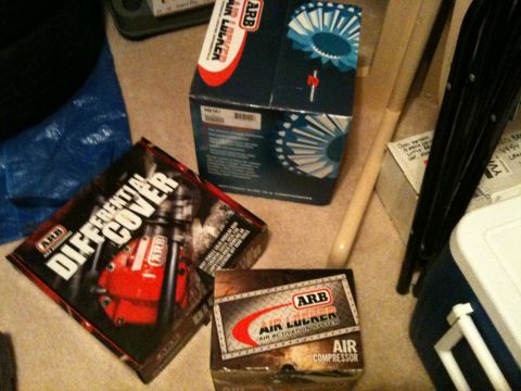 2002 Pontiac Grand Prix - Three ARB product boxes are displayed on a carpeted floor. One box is for a differential cover, and the other two are for air lockers and a…
