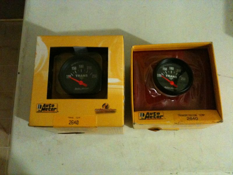 Two Auto Meter transmission temperature gauges in yellow boxes.