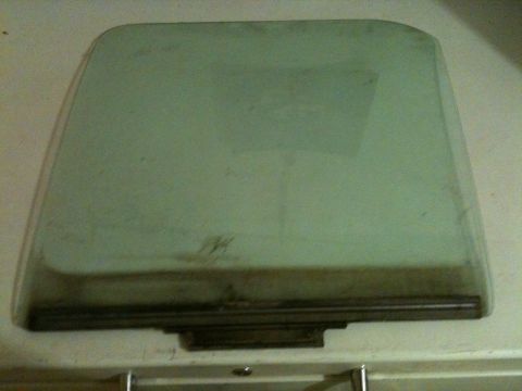 2002 Pontiac Grand Prix - A close-up of a green tinted car window with a dark frame. The window appears to be a quarter glass or vent window.