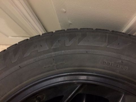 2002 Pontiac Grand Prix - A close-up view of a tire shows the brand name "WANDA" embossed in large letters. Text below indicates "MADE IN CHINA" and "DOT 4HPI".