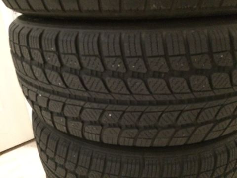 2002 Pontiac Grand Prix - A stack of four dark-colored tires with a detailed tread pattern is shown. The tires appear to be winter tires, possibly with studs, as sma…