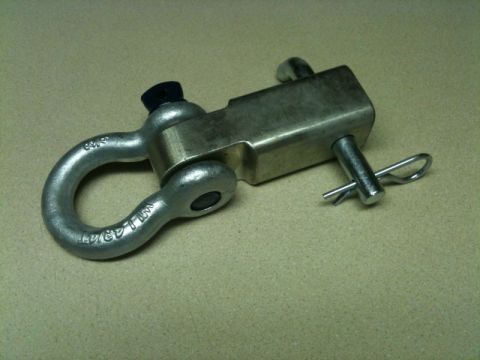 2002 Pontiac Grand Prix - A metal shackle with a clevis pin and cotter pin is shown on a textured surface. The shackle has markings that appear to indicate a weight…