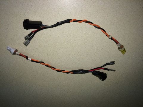 2002 Pontiac Grand Prix - Two wiring harnesses with various connectors and a fuse holder are laid out on a speckled countertop.