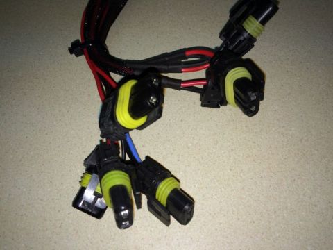 2002 Pontiac Grand Prix - A wiring harness with multiple black connectors, each featuring a bright yellow seal, is shown. The harness has red and black wires bundled…