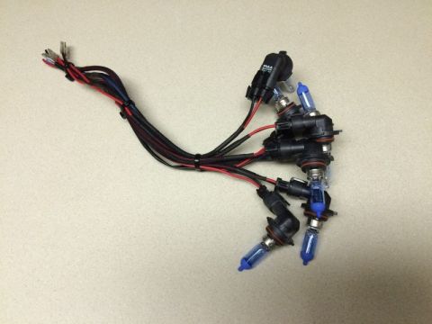 2002 Pontiac Grand Prix - A bundle of HID or LED headlight bulbs with wiring harnesses is laid out on a speckled countertop.