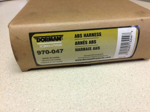 2002 Pontiac Grand Prix - A close-up shot of a Dorman OE Solutions box for an ABS Harness, part number 970-047. The box is made of cardboard and shows product inform…