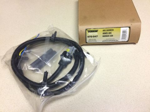 2002 Pontiac Grand Prix - A Dorman ABS harness part number 970-047 is shown in its packaging next to its cardboard box. The box is labeled "ABS HARNESS" in multiple…