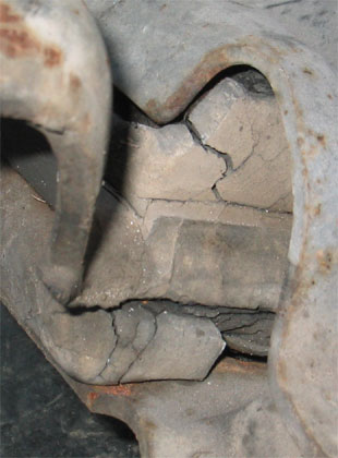 1996 Ford Crown Victoria - This close-up shows a severely cracked suspension component, indicating a potential failure point.